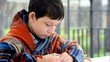School age boy draws something outdoor