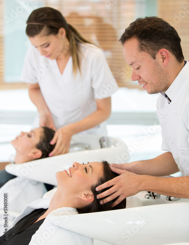 Photo: Hairdresser washing woman hair Hairdresser washing woman hair