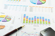 Financial paper charts and graphs with iphone and calculator