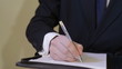 Businessman writing and signing a contract