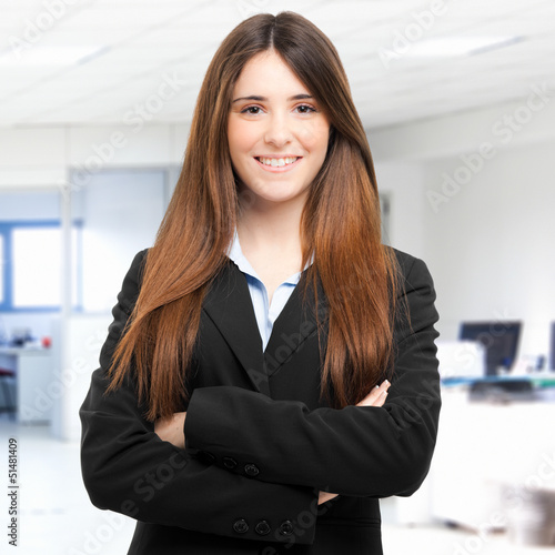 Photo: Smiling businesswoman in her office Smiling businesswoman in her office