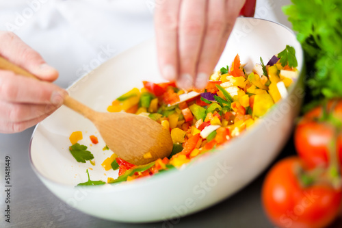 Photo: Chef preparing a salad Chef preparing a salad