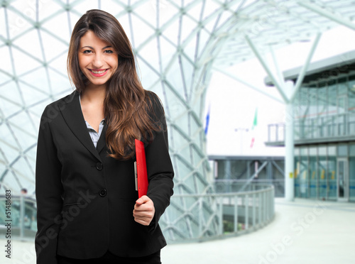 Photo: Businesswoman holding documents Businesswoman holding documents