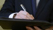 Businessman writing and signing a contract