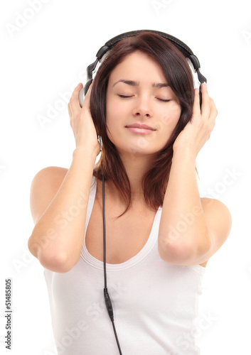 Photo: Woman with headphones listening music on player Woman with headphones listening music on player