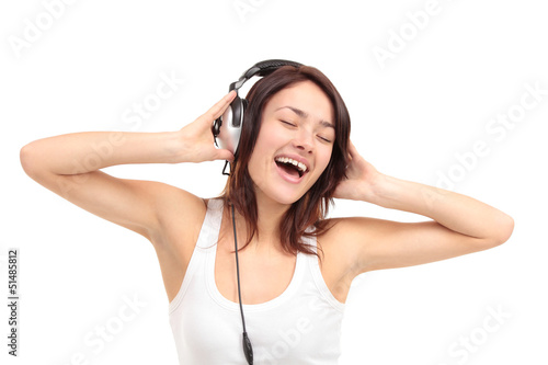 Photo: Woman with headphones listening music on player Woman with headphones listening music on player