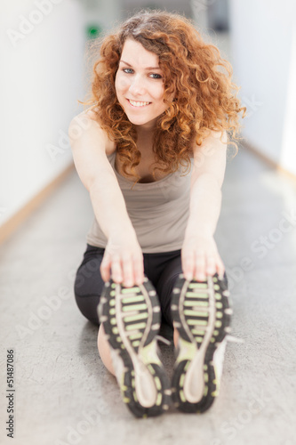 Photo: Young woman doing stretching exercise Young woman doing stretching exercise