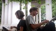 Schoolmates at art school, young man and woman drawing monument