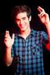 Young man dancing and enjoying music at disco