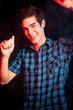 Young man dancing and enjoying music at disco