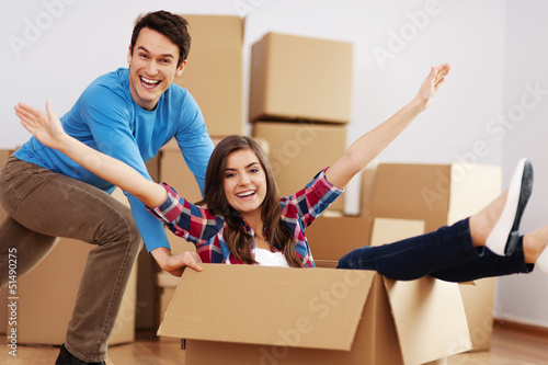 Photo: Couple having fun in new home . Couple having fun in new home .