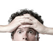 man above the mouth holding hands against forehead in disbelief