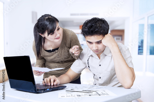 Photo: Couple paying bills online Couple paying bills online