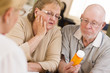 Doctor or Nurse Explaining Prescription Medicine to Senior Coupl