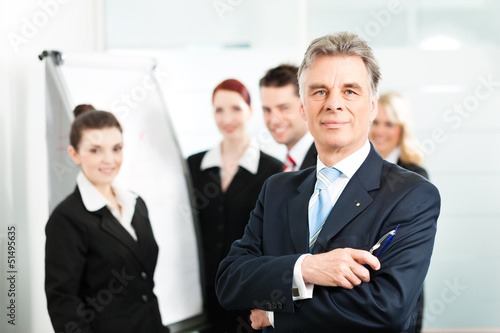 Photo: Business Team with leader in office Business Team with leader in office