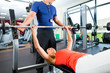 woman and Personal Trainer in gym
