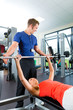 Photo: woman and Personal Trainer in gym woman and Personal Trainer in gym