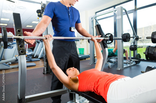 Photo: woman and Personal Trainer in gym woman and Personal Trainer in gym