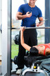 woman and Personal Trainer in gym
