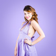 Attractive young pinup girl in retro purple dress