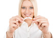 Young woman breaking a cigarette isolated on white