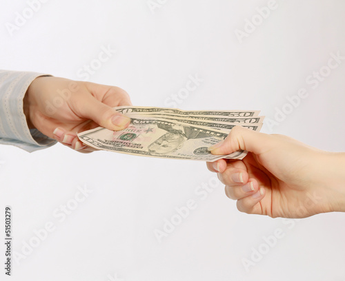 Photo: Hand giving money, isolated on white background Hand giving money, isolated on white background