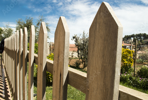 Photo: wooden fence and blue sky background wooden fence and blue sky background
