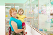  woman with child chooses  at  pharmacy