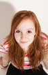 portrait of cute redheaded girl, background wall