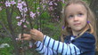 Smiling Child Playing with Spring Flowers, Girl Laughing in Park
