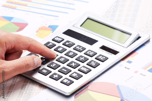 Photo: Accountant working with calculator. Accountant working with calculator.