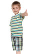 Smiling little boy holds his thumb up