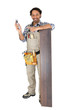 Man standing by laminate flooring with a mobile telephone