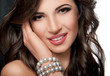 portrait of beautiful girl with a wide smile. Pearls