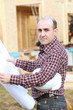 Photo: craftsman holding a blueprint craftsman holding a blueprint