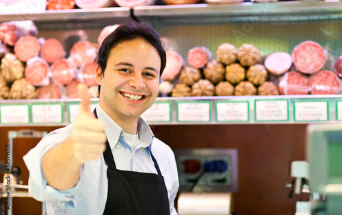 Photo: Shopkeeper serving a customer in a grocery store Shopkeeper serving a customer in a grocery store