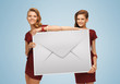 girls holding big envelope