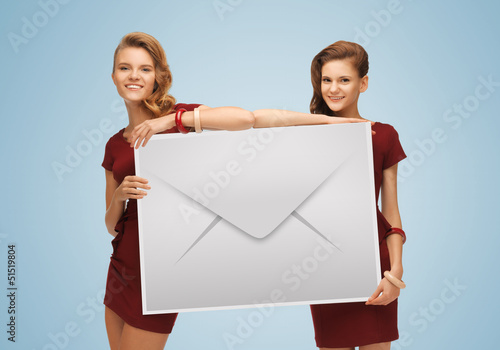 Photo: girls holding big envelope girls holding big envelope