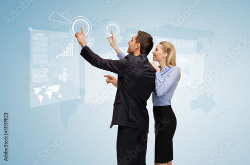 Photo: man and woman working with virtual screen man and woman working with virtual screen