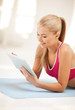 woman lying on the floor with tablet pc