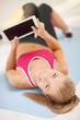 woman lying on the floor with tablet pc