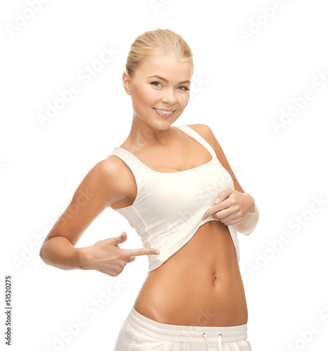 Photo: beautiful sporty woman pointing at her abs beautiful sporty woman pointing at her abs