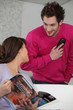 Couple at home with a telephone