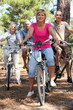 Foto: Two middle-aged couples riding bicycles Two middle-aged couples riding bicycles