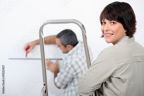 Photo: Couple decorating home Couple decorating home