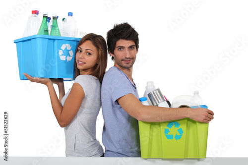 Photo: Young couple recycling bottles Young couple recycling bottles