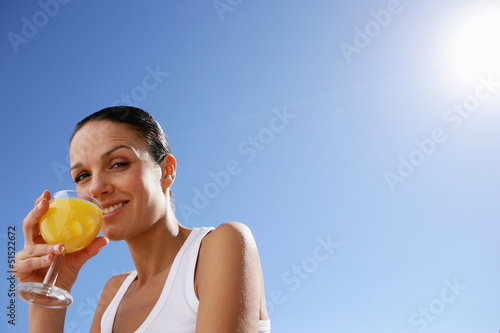 Photo: Woman enjoying fruit juice outdoors Woman enjoying fruit juice outdoors
