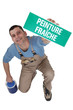 Photo: Man holding wet paint sign Man holding wet paint sign