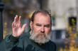 Homeless man waving