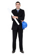 Businessman holding helmet and blueprints